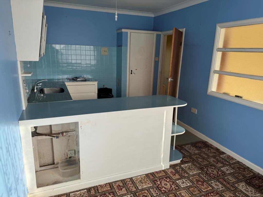 Lot: 62 - GROUND FLOOR FLAT WITH GARAGE FOR INVESTMENT OR OCCUPATION - Kitchen with painted walls and units